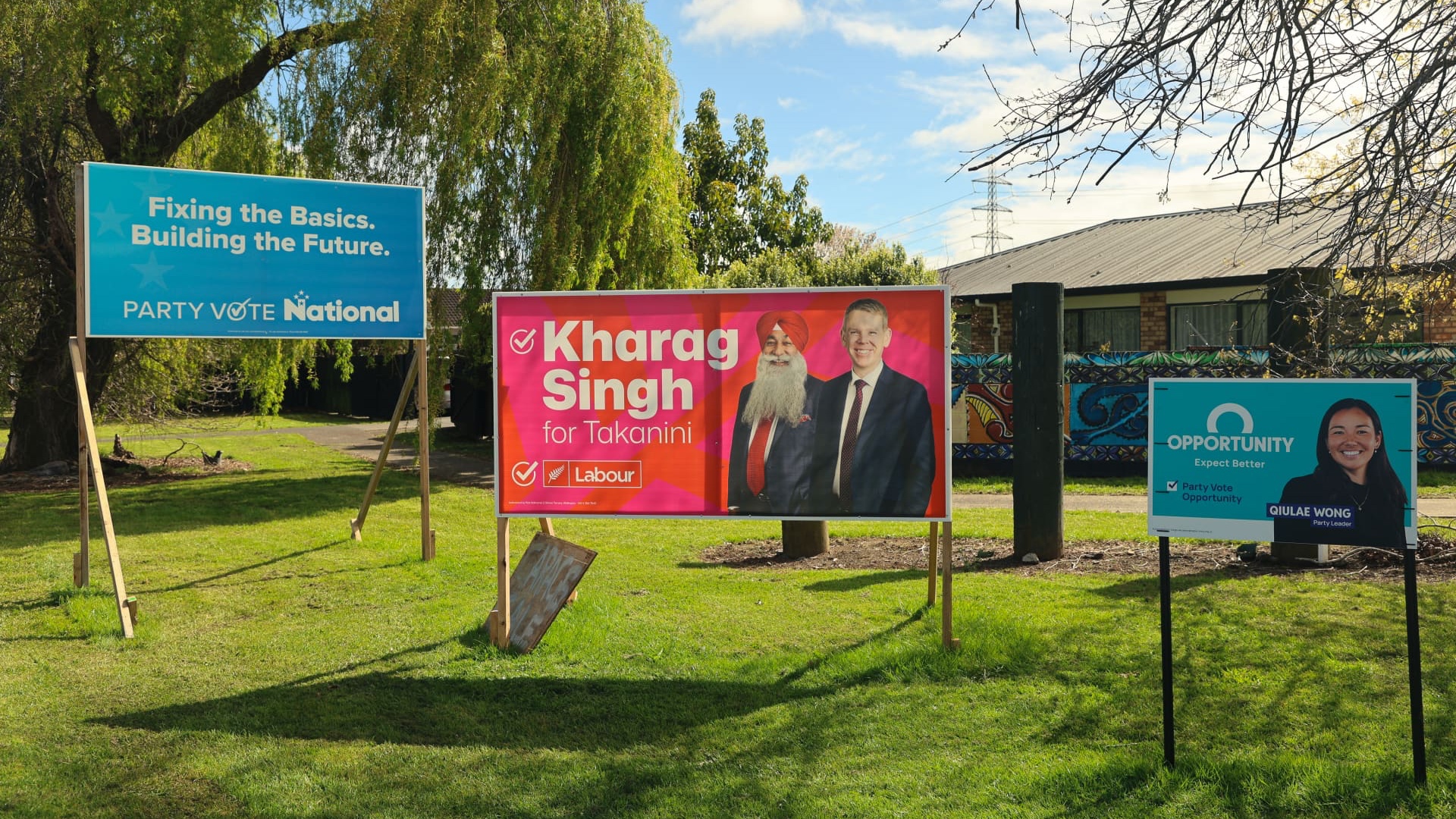 Campaign hoardings for Labour candidate Kharag Singh and other political parties sit on the side of a road in the South Auckland electorate of Takanini ahead of the November election. (RNZ/Blessen Tom)