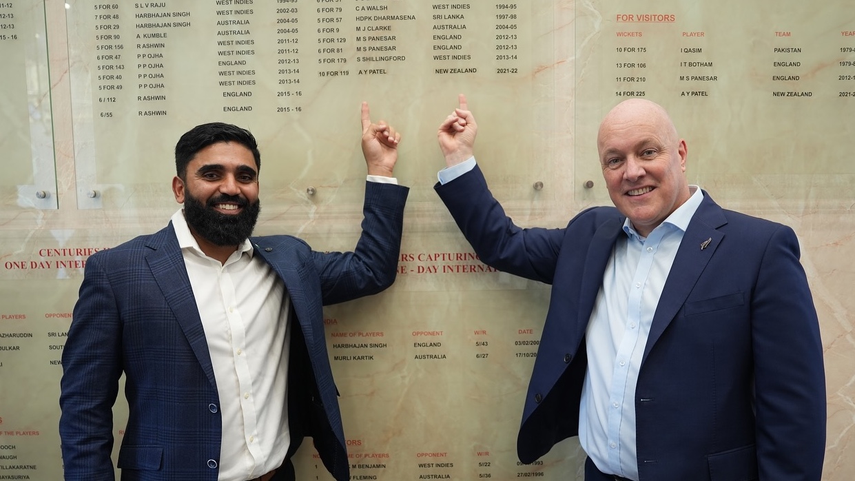 Ajaz Patel with prime minister Christopher Luxon during their visit to India in March 2025, pointing to his name on the Wankhede Stadium honours board in Mumbai. (Supplied photo)